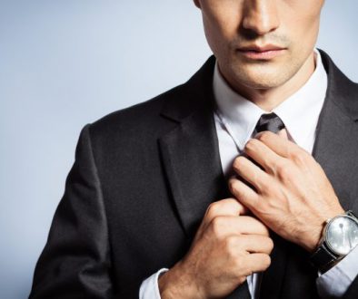 Man in suit fixing his tie